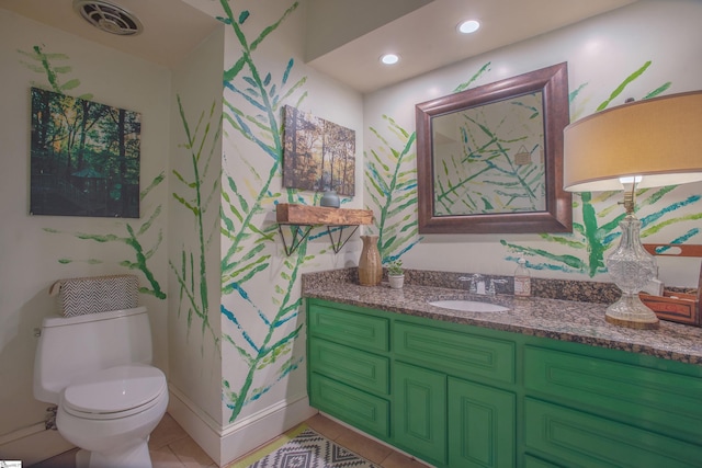 bathroom with vanity, toilet, and tile patterned floors