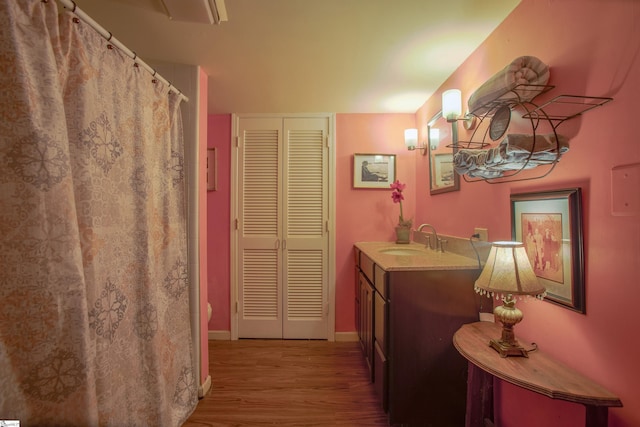 bathroom with hardwood / wood-style floors, toilet, and vanity