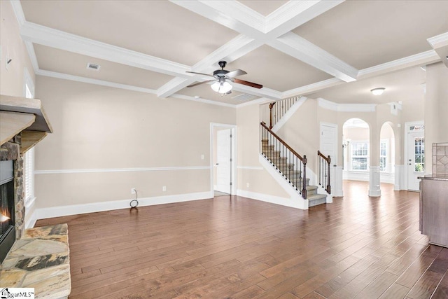 living room with coffered ceiling, beamed ceiling, dark hardwood / wood-style flooring, a fireplace, and ornamental molding