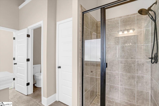 bathroom featuring an enclosed shower, french doors, and toilet