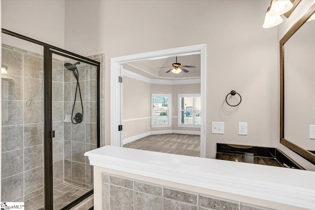 bathroom featuring ceiling fan, crown molding, and an enclosed shower