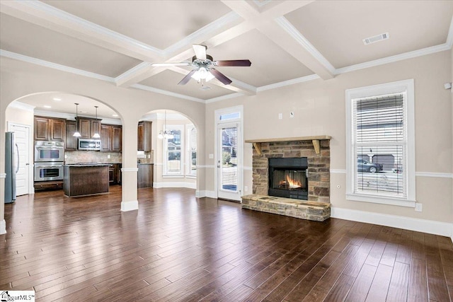 living room featuring beam ceiling, dark wood-type flooring, coffered ceiling, and a fireplace