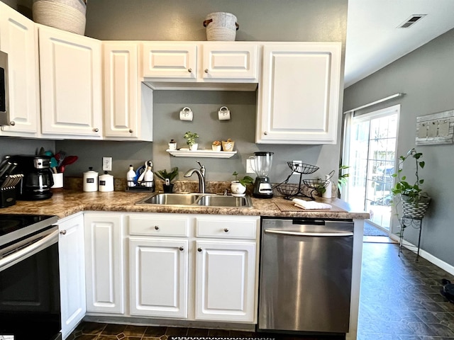 kitchen with appliances with stainless steel finishes, sink, and white cabinetry