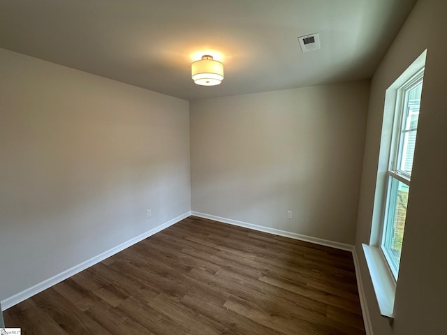 empty room with dark wood-type flooring