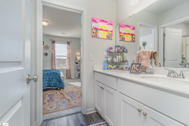 bathroom featuring hardwood / wood-style floors and vanity