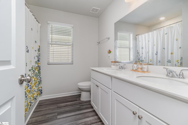 bathroom featuring vanity, toilet, and hardwood / wood-style floors