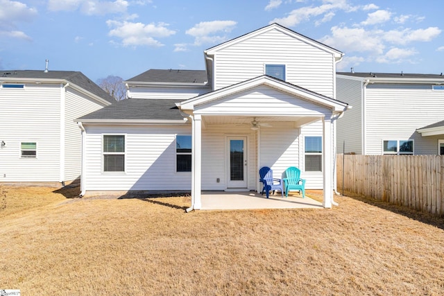 rear view of property with a patio area, a yard, and ceiling fan