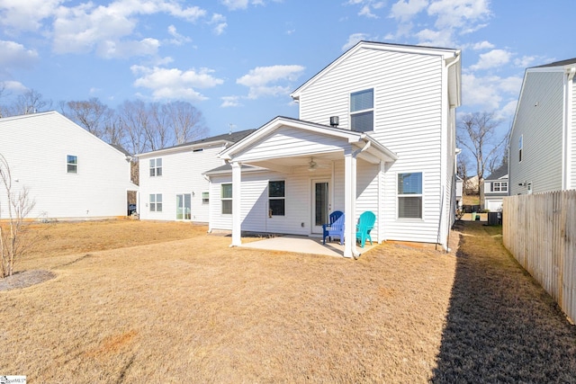 rear view of property featuring ceiling fan and a patio area