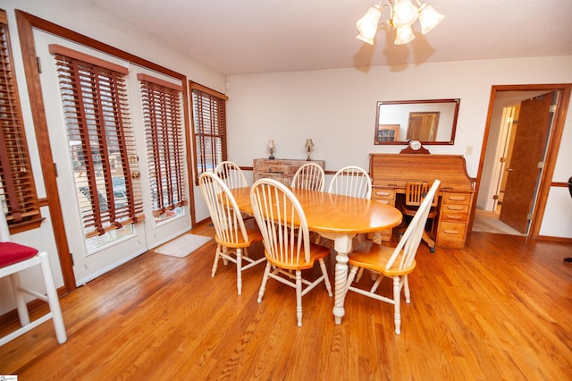 dining space with hardwood / wood-style flooring