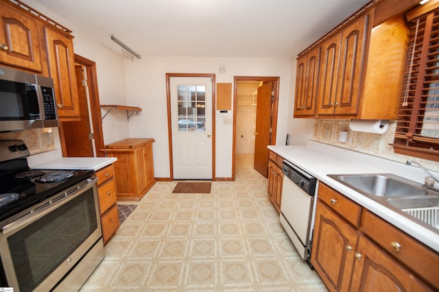 kitchen with stainless steel appliances, tasteful backsplash, and sink