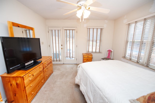 carpeted bedroom featuring french doors, ceiling fan, and access to outside