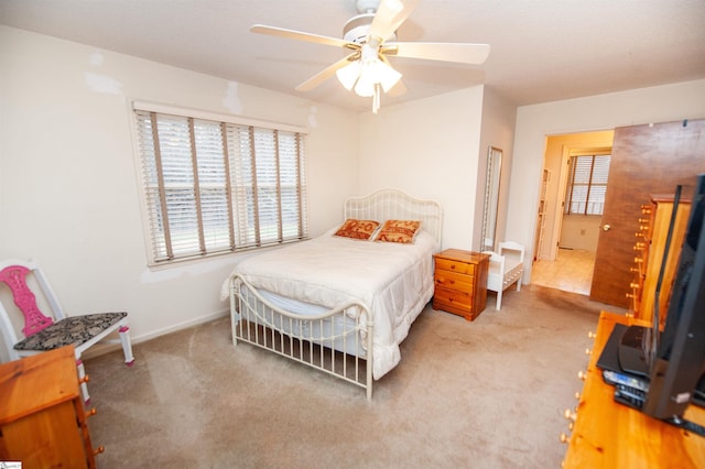 bedroom featuring light carpet and ceiling fan