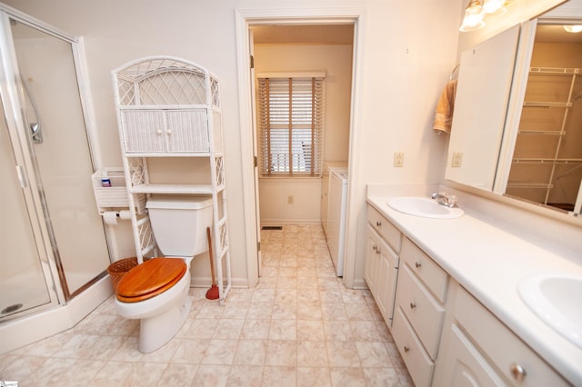 bathroom featuring vanity, a shower with door, and toilet