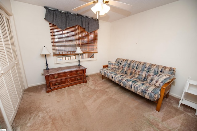 interior space with ceiling fan and light colored carpet