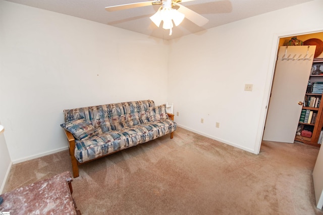 sitting room featuring light carpet and ceiling fan