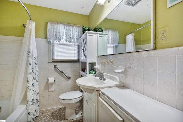 full bathroom featuring tile patterned flooring, toilet, shower / tub combo, tile walls, and vanity