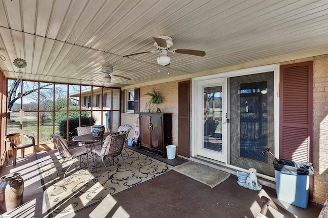 sunroom / solarium featuring ceiling fan