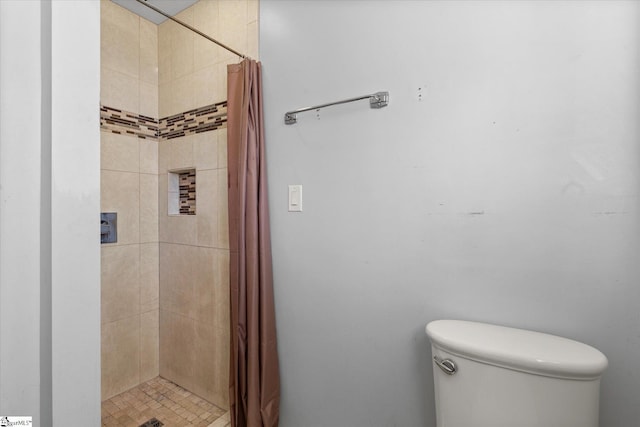 bathroom featuring toilet and a shower with shower curtain