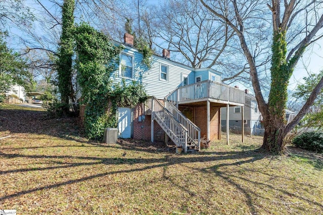 back of house featuring a deck, a yard, and cooling unit