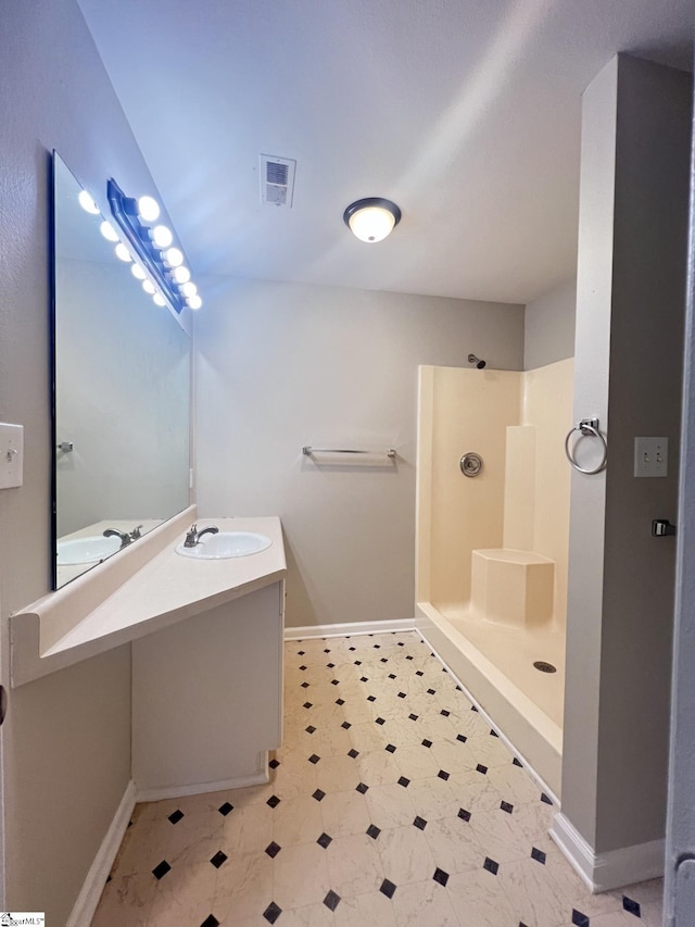 bathroom featuring vanity and a shower