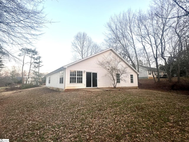 back of house with a lawn