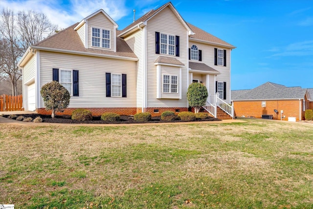 view of front of home featuring a front yard and a garage