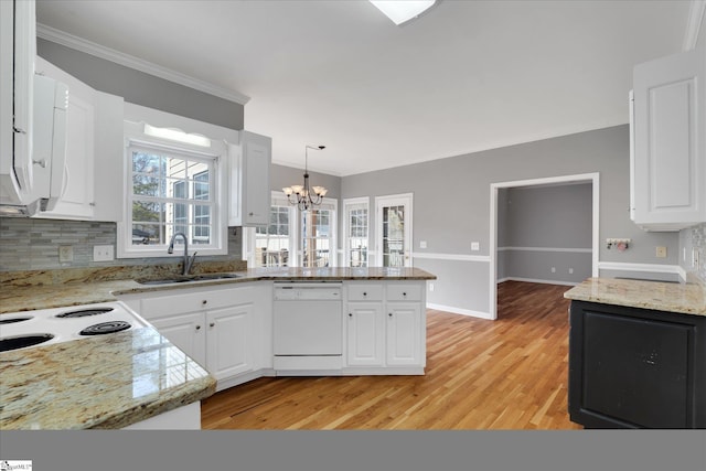 kitchen featuring sink, white dishwasher, kitchen peninsula, white cabinets, and hanging light fixtures