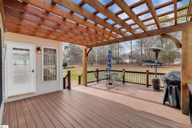 wooden terrace with a lawn and a pergola