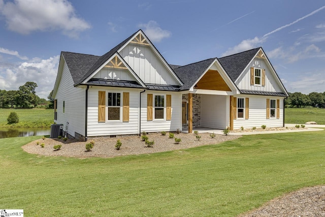 view of front of property with central AC unit and a front yard