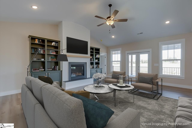 living room featuring french doors, lofted ceiling, ceiling fan, and light hardwood / wood-style flooring