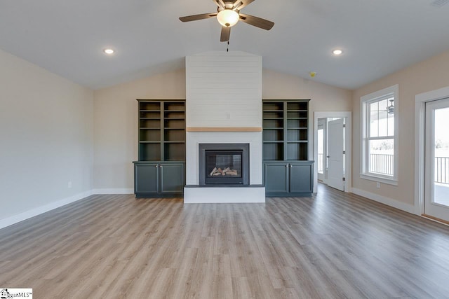 unfurnished living room featuring a fireplace, ceiling fan, light wood-type flooring, and vaulted ceiling