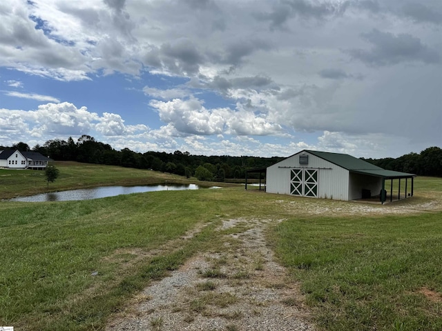 view of yard featuring an outbuilding and a water view