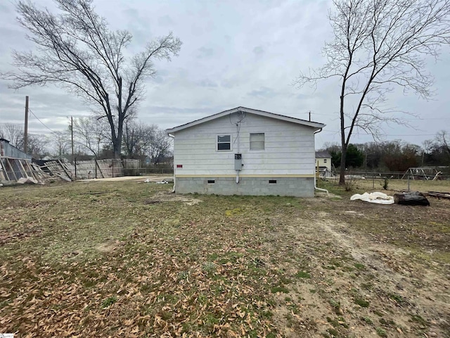 view of side of home with a lawn