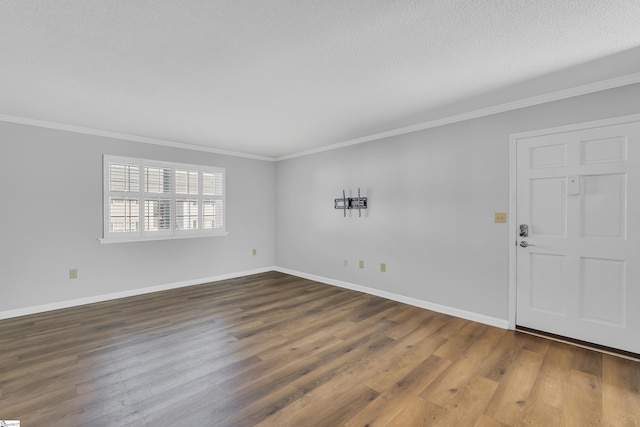 unfurnished room featuring a textured ceiling, dark wood-type flooring, and crown molding