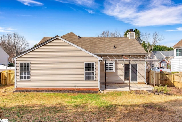 rear view of property with a yard and a patio