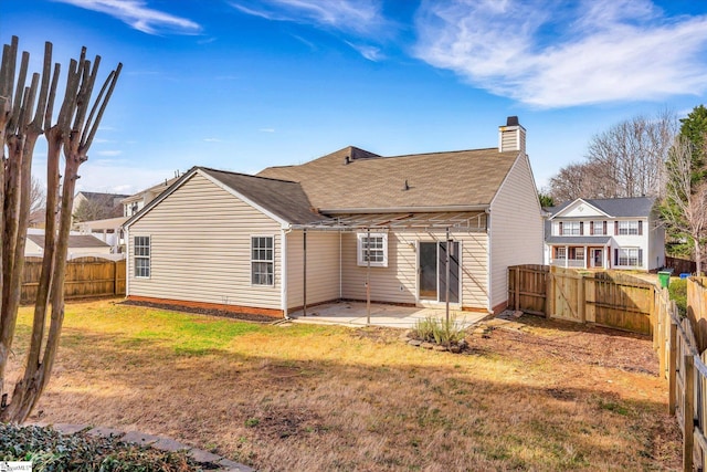 rear view of property with a yard and a patio