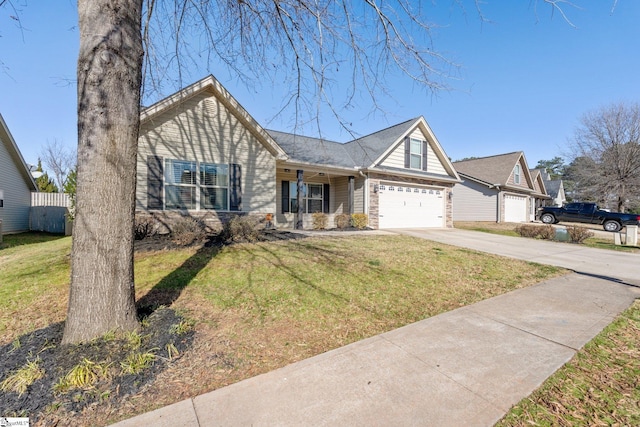 ranch-style house featuring covered porch, a front yard, and a garage