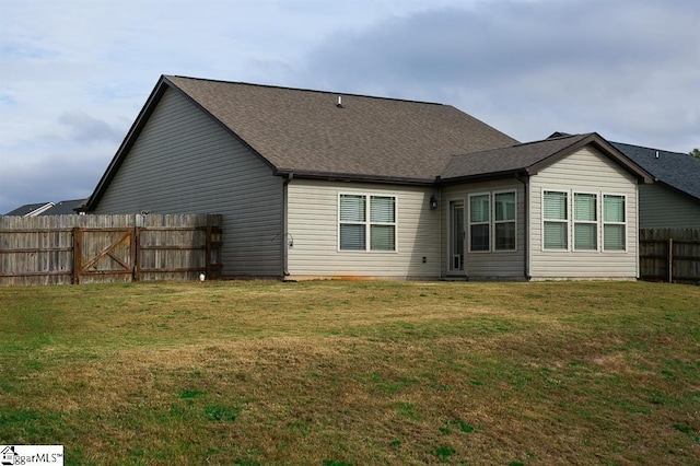 back of house with a yard