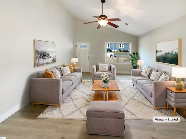 living room with lofted ceiling, visible vents, light wood-style flooring, ceiling fan, and baseboards