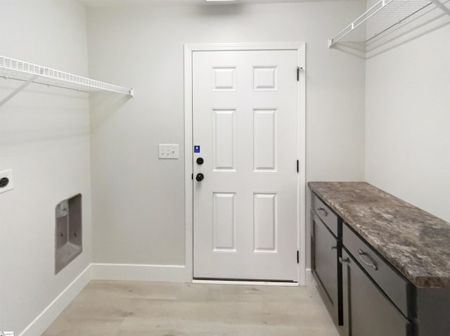 10 Maplecroft St, Greenville, SC 29609 - clothes washing area featuring light wood-type flooring, cabinet space, baseboards, and electric dryer hookup