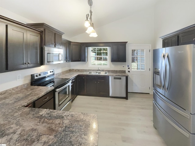 10 Maplecroft St, Greenville, SC 29609 - kitchen with lofted ceiling, hanging light fixtures, light wood-style flooring, appliances with stainless steel finishes, and a sink