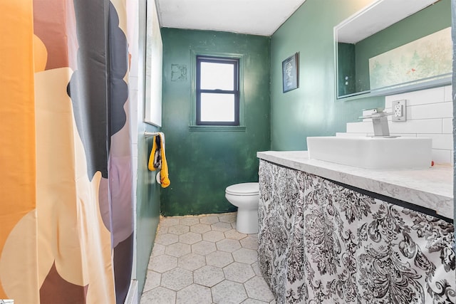 bathroom with vanity, toilet, and tile patterned floors