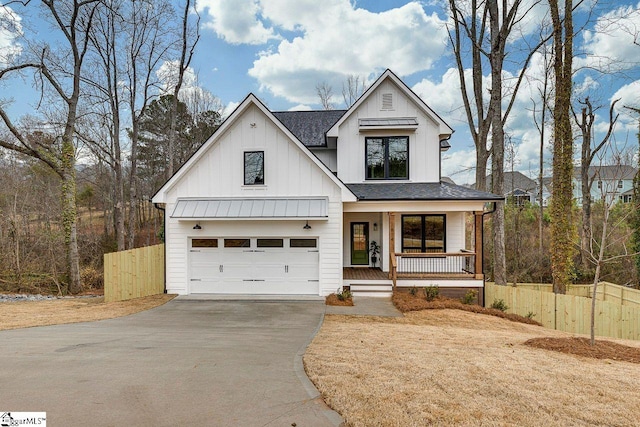 modern inspired farmhouse with a porch and a garage