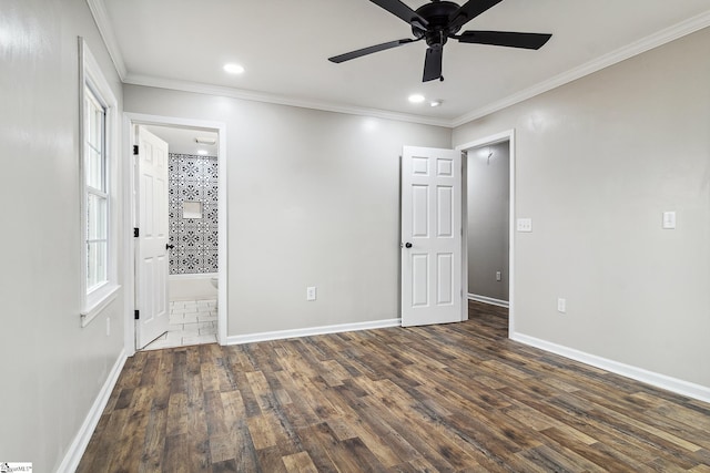 unfurnished bedroom featuring ensuite bathroom, ceiling fan, crown molding, and dark hardwood / wood-style floors