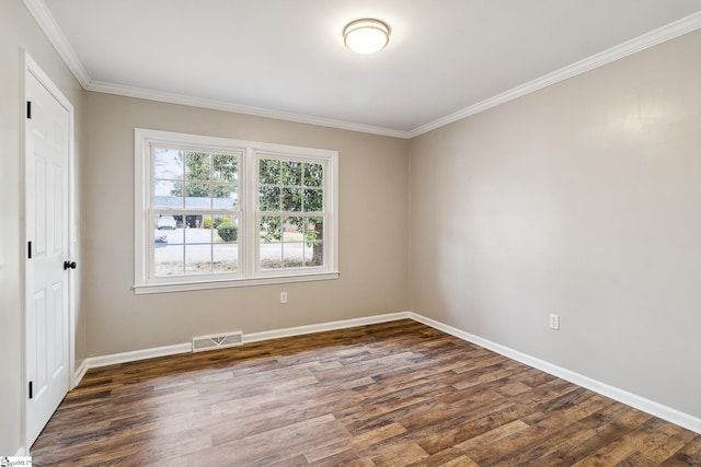 empty room featuring crown molding and dark hardwood / wood-style flooring