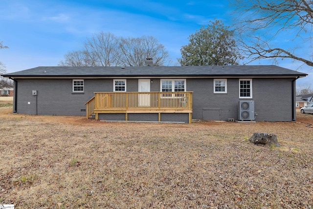 back of property with a yard and a deck