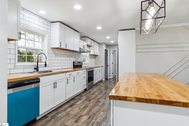 kitchen with wood counters, pendant lighting, stainless steel appliances, and white cabinets