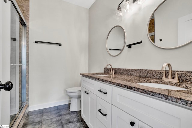 bathroom featuring vanity, tile patterned flooring, toilet, and walk in shower