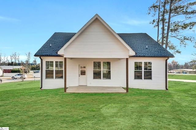 back of house featuring a yard and a patio area