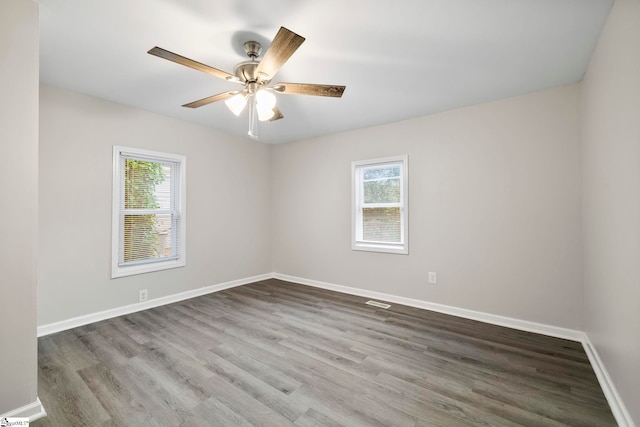 unfurnished room with ceiling fan, hardwood / wood-style flooring, and plenty of natural light